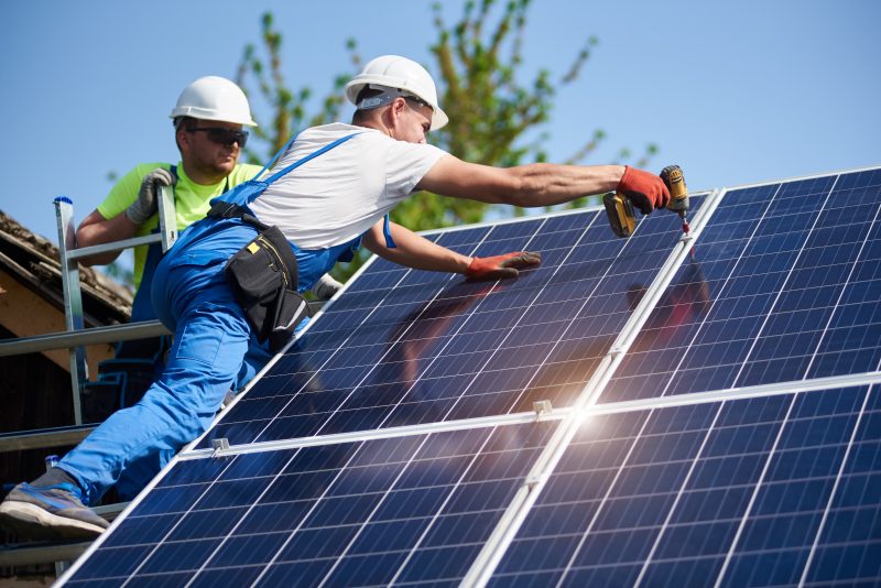 Man working on solar panel