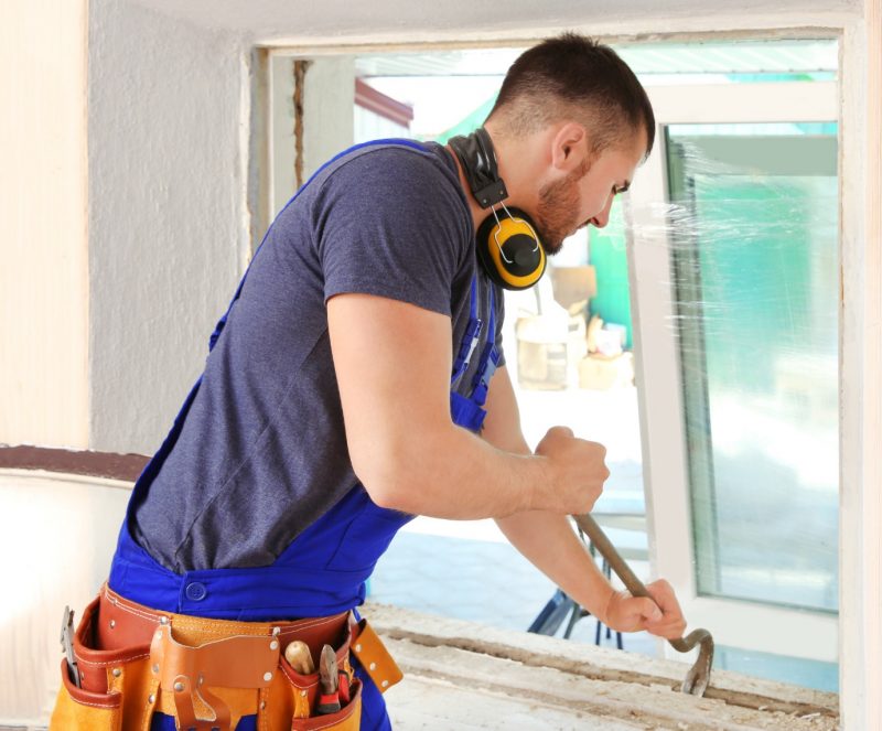 a man replacing a window