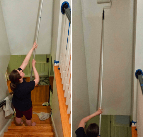 A girl is painting stairs wall