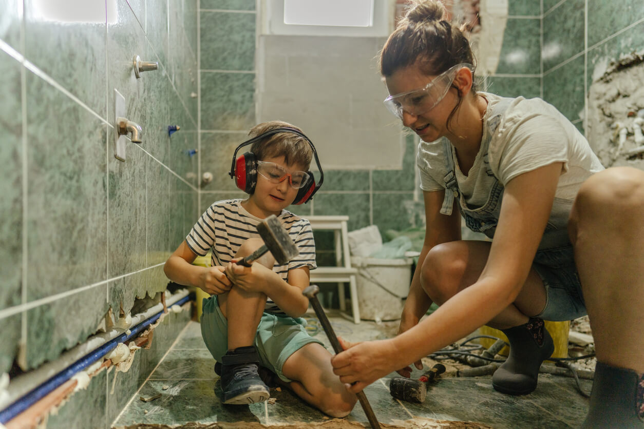 Mother Child Are Setting Bathroom tiles for Better Look