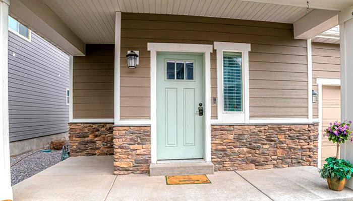 A Door Wall Of A House Neatly Decorated With Stone Siding