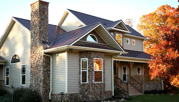 A Modern House that's exterior is decorated with gray and blue tiles and beautiful stones has a separate charming level in house