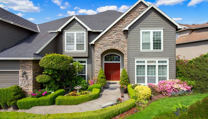 A very beautiful house deigned with stones and has a fresh look due to its greenery