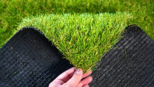 Two sides of artificial lawn grass is shown