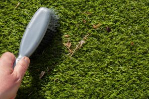 Cleaning Of Grass With brush is important