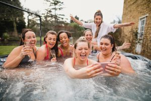 girls are enjoying hot water tub in happy mood