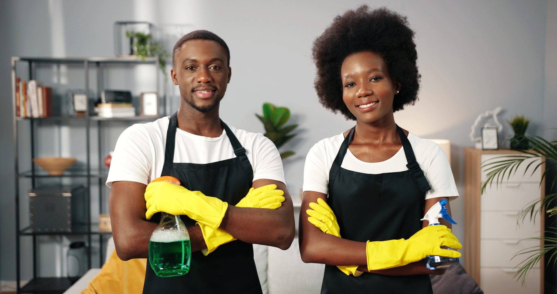 House cleaners have cleaning tools in their hands