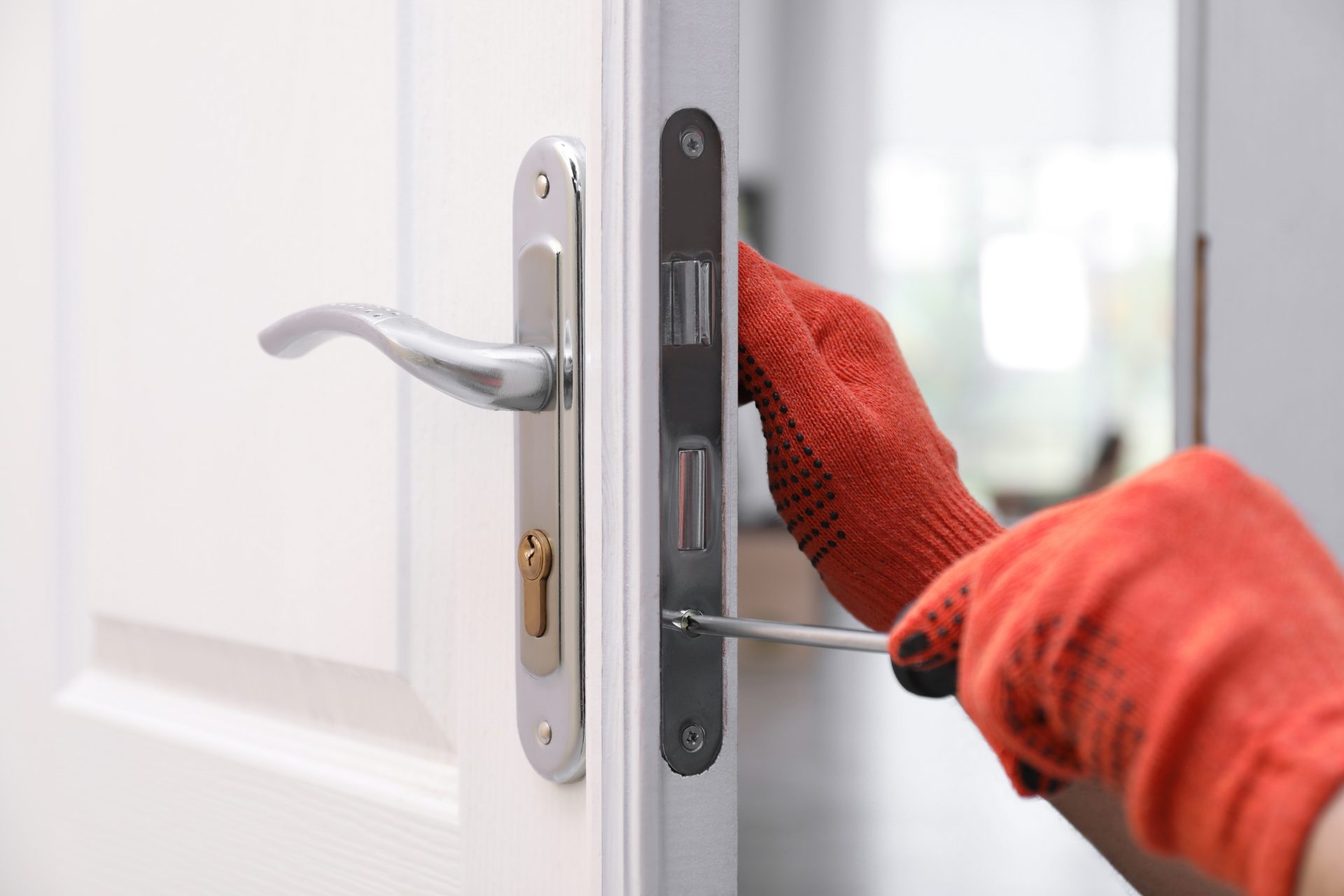 A man is repairing a door lock