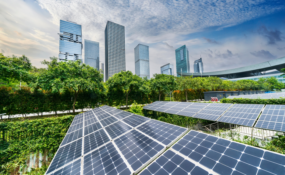 Many solar panels are fixed on the top roof of a building