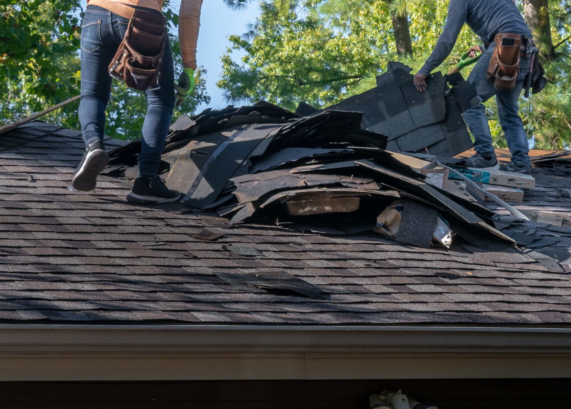 Men Are Examining A Roof Storm Damage SO That They Can Repair It
