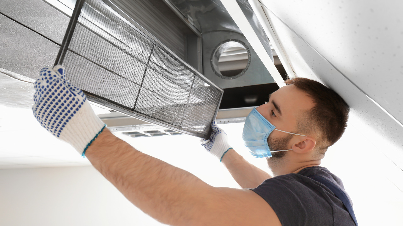 A Man Is Checking HVAC Ducts Sweating