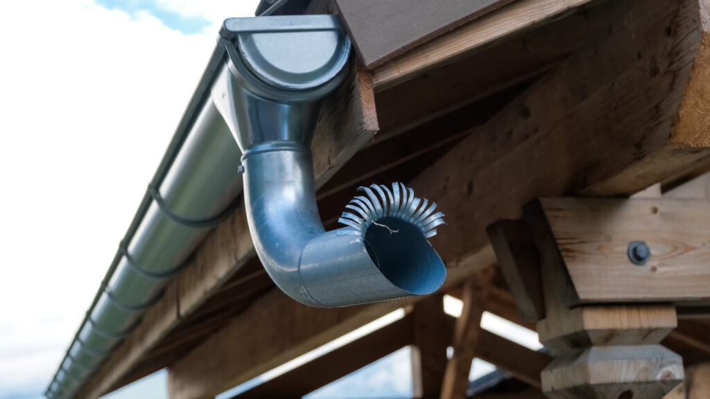 Mount Downspout Elbow to the Outlet Tube